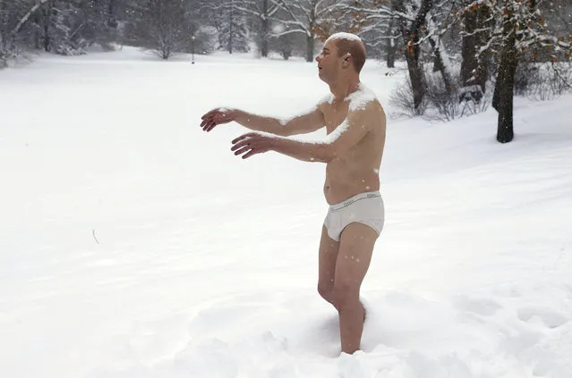 A statue of a man sleepwalking in his underpants is surrounded by snow on the campus of Wellesley College, in Wellesley, Mass., Wednesday, Feb. 5, 2014. The sculpture entitled "Sleepwalker" is part of an exhibit by sculptor Tony Matelli at the college's Davis Museum. (AP Photo/Steven Senne)