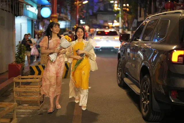Vietnamese tourists walk at Binondo district, said to be the oldest Chinatown in the world, in Manila, Philippines on Tuesday, February 6, 2024. (Photo by Aaron Favila/AP Photo)
