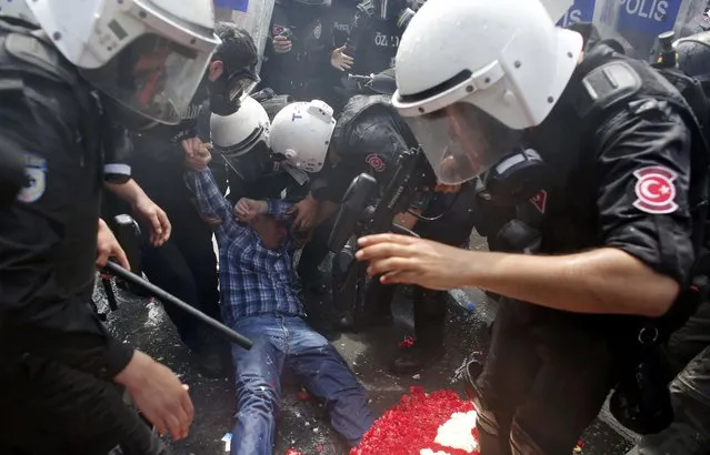 A protester lies in front of policemen during clashes with police in Besiktas neighbourhood of Istanbul, Turkey, May 1, 2015. (Photo by Murad Sezer/Reuters)