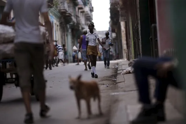 People walk on a street in Havana, March 17, 2016. (Photo by Ueslei Marcelino/Reuters)