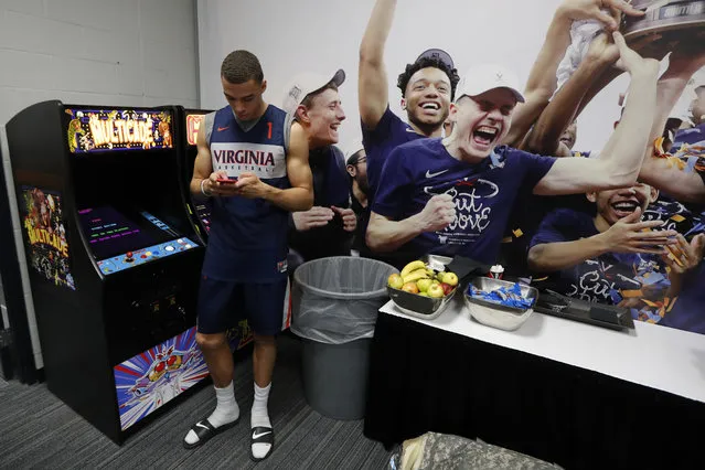 Virginia's Francesco Badocchi texts during a news conference in the locker room for the championship of the Final Four NCAA college basketball tournament, Sunday, April 7, 2019, in Minneapolis. Virginia will play Texas Tech on Monday for the national championship. (Photo by Charlie Neibergall/AP Photo)