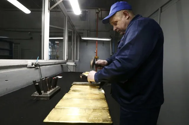 An employee stamps gold bars at the Prioksky Non-Ferrous Metals Plant in Kasimov, Russia February 14, 2017. (Photo by Sergei Karpukhin/Reuters)
