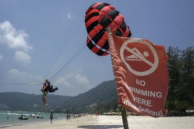 A tourist parasails at Patong beach in Phuket, Thailand March 19, 2016. (Photo by Athit Perawongmetha/Reuters)