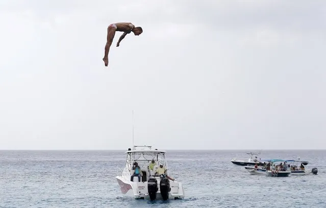 Sasha Kutsenko from Ukraine performs a dive during the FINA High Diving World Cup in Cozumel, Mexico, May 10, 2015. (Photo by Victor Ruiz Garcia/Reuters)