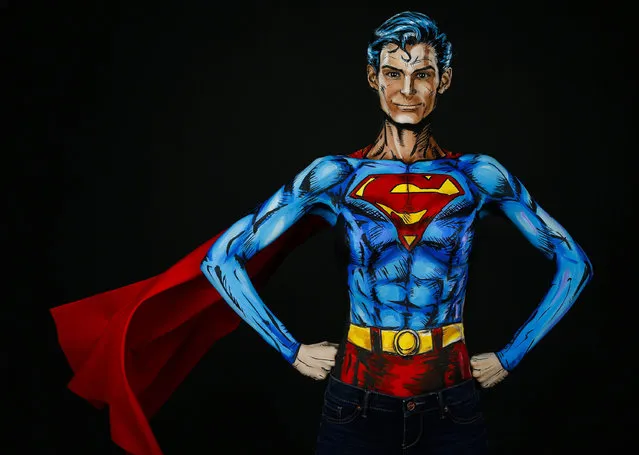 In this March 19, 2016 photo, Kay Pike poses for a photo after she transformed herself using body paint and latex into Superman at her home in Calgary, Alberta. The Canadian artist turns her body into different characters for an Internet audience, one dab of paint at a time. (Photo by Jeff McIntosh/The Canadian Press via AP Photo)