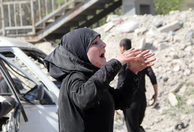 A women reacts following a reported air strike by government forces on April 2, 2014, in the Sakhur neighborhood in the northern Syrian city of Aleppo. More than 150,000 people have been killed in Syria since the conflict began in March 2011, the Syrian Observatory for Human Rights said in a new toll released. (Photo by Mohammed Al-Khatieb/AFP Photo)