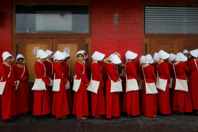 Women dressed as handmaids promoting the Hulu original series “The Handmaid's Tale” stand along a public street during the South by Southwest (SXSW) Music Film Interactive Festival 2017 in Austin, Texas, U.S., March 11, 2017. (Photo by Brian Snyder/Reuters)