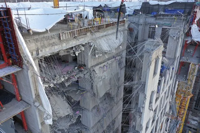 The collapsed exterior wall of an apartment under construction is seen at a site in Gwangju, South Korea, Wednesday, January 12, 2022. South Korean rescuers on Wednesday resumed their search for six missing construction workers believed to be trapped at a collapsed construction site in the southern city of Gwangju. (Photo by Jung Hee-sung/Yonhap via AP Photo)