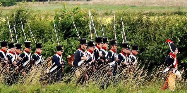In this June 16, 2007,  file photo, actors play the part of soldiers during a re-enactment of the Battle of Waterloo in Braine-l'Alleud, near Waterloo, Belgium. The Battle of Waterloo, fought on June 18, 1815, was Napoleon Bonaparte's last battle, as his defeat put a final end to his rule as Emperor of France. (AP Photo/Geert Vanden Wijngaert, File)