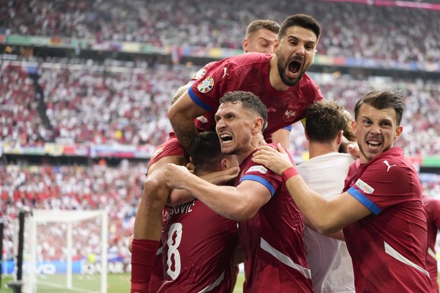 Serbia's players celebrate their sides first goal against Slovenia during a Group C match between Slovenia and Serbia at the Euro 2024 soccer tournament in Munich, Germany, Thursday, June 20, 2024. (Photo by Matthias Schrader/AP Photo)