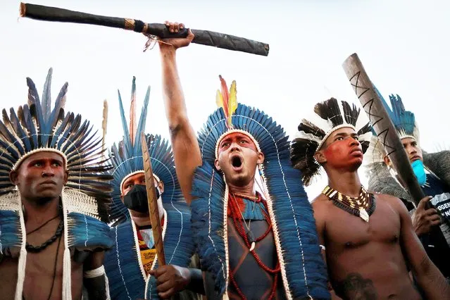 Indigenous people take part in a protest against a proposed bill allowing commercial agriculture and mining on protected tribal reservations, curtailing indigenous land rights, in Brasilia, Brazil on June 30, 2021. (Photo by Ueslei Marcelino/Reuters)
