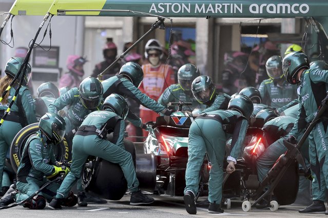 Aston Martin driver Lance Stroll of Canada changes tires at his box during the Formula 1 Spanish Grand Prix race at the Barcelona Catalunya racetrack in Montmelo, near Barcelona, Spain, Sunday, June 23, 2024. (Photo by Thomas Coex, Pool Photo via AP Photo)