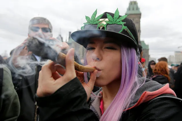 A woman smokes marijuana during the annual 4/20 marijuana rally on Parliament Hill in Ottawa, Ontario, Canada, April 20, 2017. (Photo by Chris Wattie/Reuters)