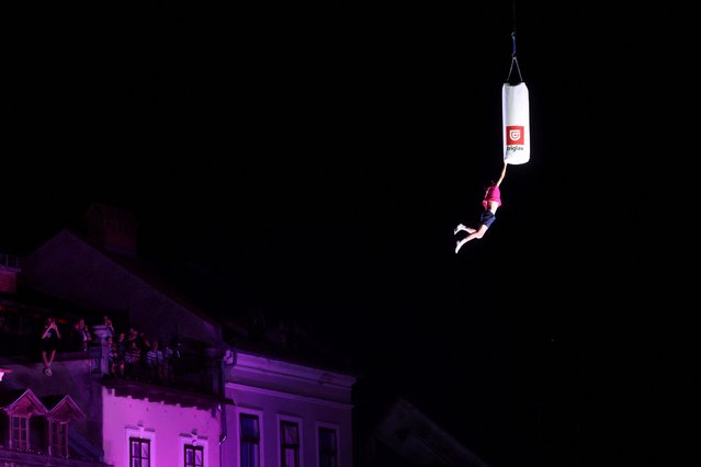 A man attempts to break the world record of the highest trampoline jump in Ljubljana, Slovenia on June 29, 2024. (Photo by Borut Zivulovic/Reuters)