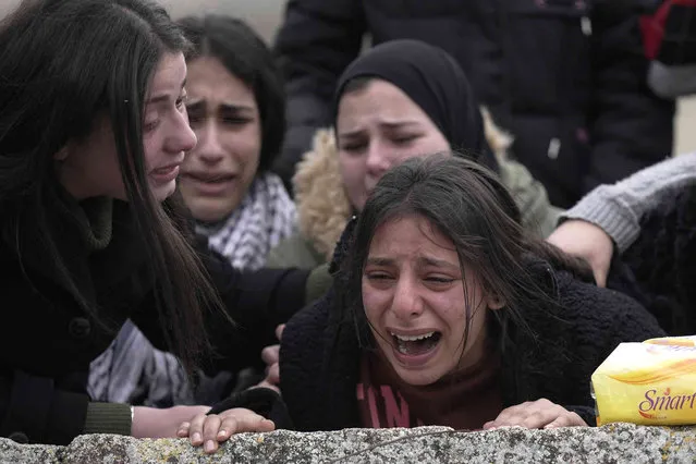 A relative mourns Palestinian Ahmad Saif, 23, who died as a result of injuries sustained on March 1, during clashes with Israeli soldiers following a demonstration, during his funeral in the West Bank village of Burqa, Wednesday, March 9, 2022. (Photo by Majdi Mohammed/AP Photo)
