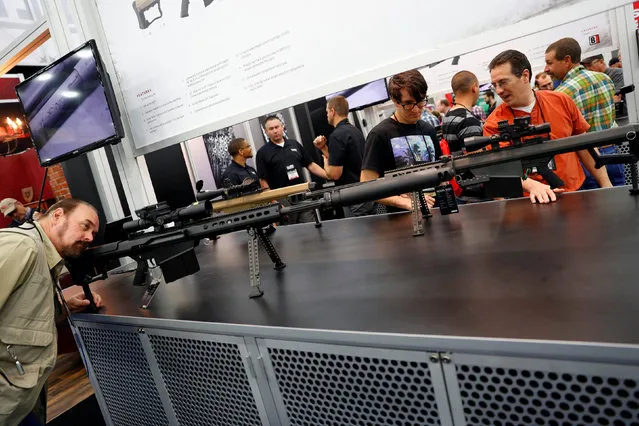 Attendees visit the trade booths during the National Rifle Association's annual meeting in Louisville, Kentucky, May 21, 2016. (Photo by Aaron P. Bernstein/Reuters)