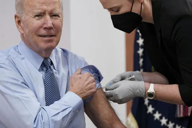 President Joe Biden receives his second COVID-19 booster shot in the South Court Auditorium on the White House campus, Wednesday, March 30, 2022, in Washington. (Photo by Patrick Semansky/AP Photo)