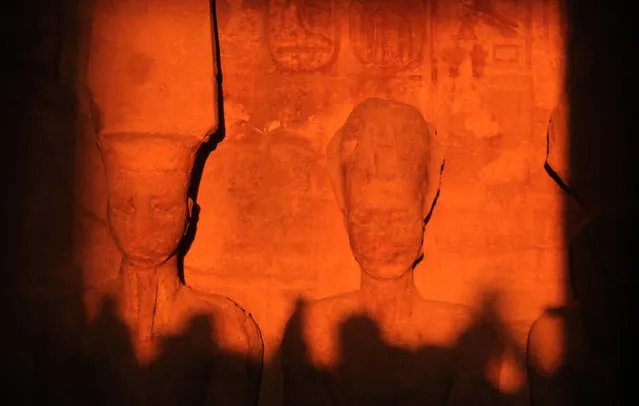 The sun illuminates the stone sculptures in the inner sanctuary of the Ramses II's (1279-1213 BC) Great Temple in Egypt's southern town of Abu Simbel during the solar alignment early on February 22, 2022. (Photo by Mohamed Asad/AFP Photo)
