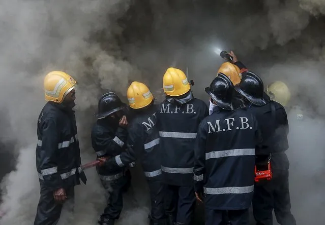 Firefighters try to extinguish a fire at a multi-storey shopping complex in Mumbai, India, July 21, 2015. (Photo by Danish Siddiqui/Reuters)