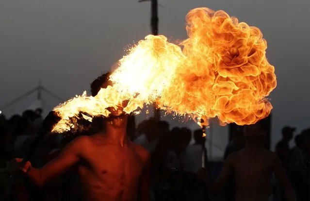 A fire breather performs during the Aoussou Carnival in Sousse, Tunisia July 26, 2015. (Photo by Anis Mili/Reuters)