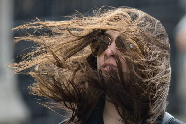 A woman is buffeted by strong winds while crossing Westminster Bridge, in central London, England on Saturday,  March 9, 2019. (Photo by Dominic Lipinski/PA Wire Press Association)