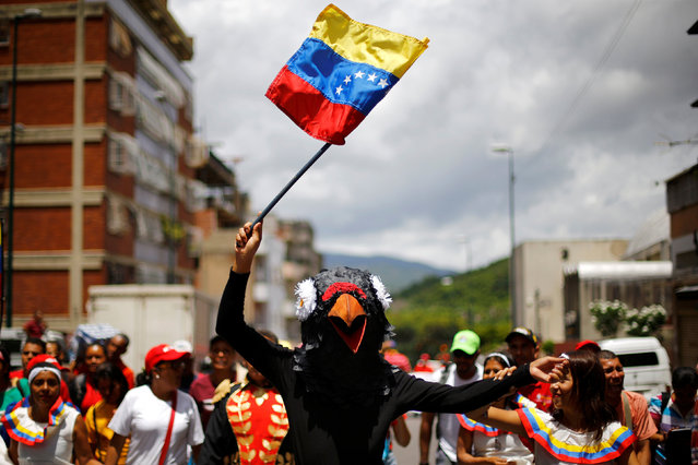 A person dressed as a bird waves a Venezuelan flag during a pro-government rally of members of the education sector in Caracas, Venezuela June 14, 2016. (Photo by Ivan Alvarado/Reuters)