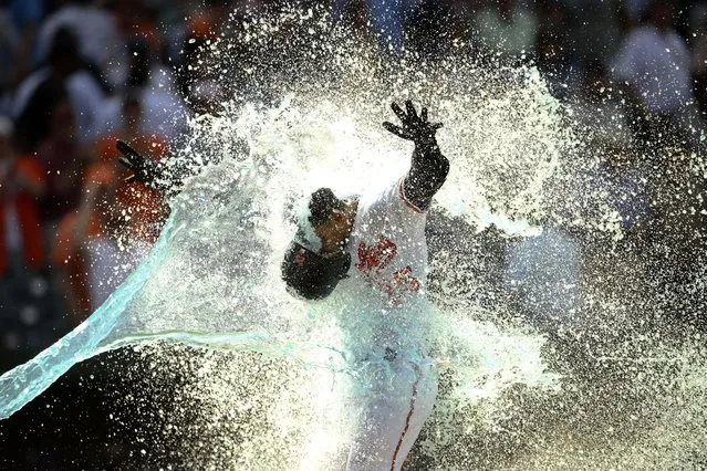 Baltimore Orioles' Anthony Santander is doused as he celebrates heading home after hitting a three-run walk off home run during the ninth inning of a baseball game against the New York Yankees, Thursday, May 19, 2022, in Baltimore. The Orioles won 9-6. (Photo by Nick Wass/AP Photo)