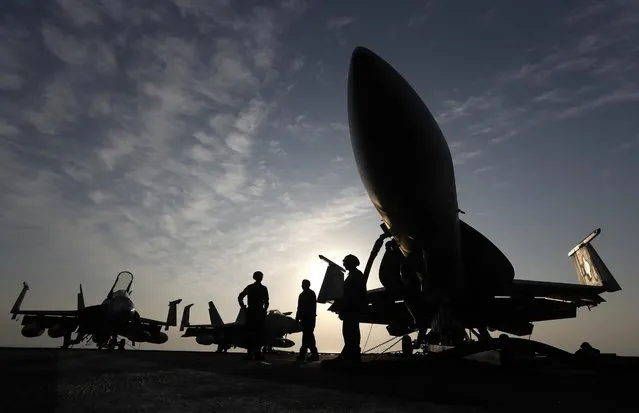 In this November 22, 2016 file photo, U.S. Navy sailors stand by fighter jets on the deck of the U.S.S. Dwight D. Eisenhower in the Persian Gulf. The United States’ Gulf allies have pushed for hawkish policies by Washington to pressure, isolate and cripple Iran, but this high-stakes strategy is now being put to the test by the surprise U.S. killing of Iran’s most powerful military commander. The killing appears to have caught America's Gulf allies off-guard and threatens to draw Gulf states further into the cross-hairs of rising tensions between Washington and Tehran. (Photo by Petr David Josek/AP Photo/File)