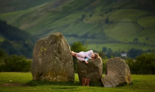 A 5,000-year-old Neolithic monument doesn’t look the comfiest place to sleep at Castlerigg stone circle in Cumbria, Britain, on June 21, 2016. (Photo by Christopher Thomond/The Guardian)