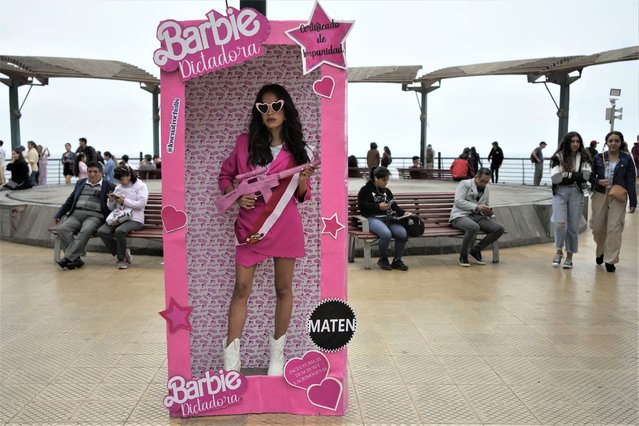 An anti-government protester, dressed as Barbie holding a fake gun, takes part in a demonstration demanding that Peruvian President Dina Boluarte call for immediate presidential elections as well as justice for those who were killed during protests earlier this year after the ouster of her predecessor, in Lima, Peru, Saturday, July 22, 2023. (Photo by Martin Mejia/AP Photo)