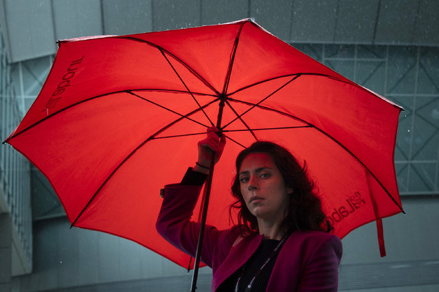 A delegate dodges heavy rain on day two of Labour Party conference in Liverpool on September 23, 2024. (Photo by James Glossop/The Times)