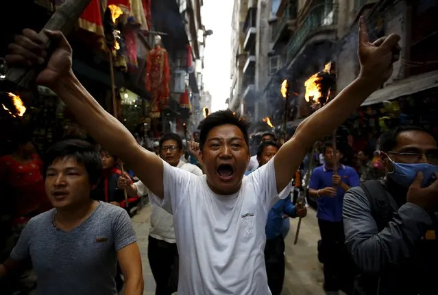 Protesters chanting slogans take part in a rally organised by the 30-party alliance led by a hardline faction of former Maoist rebels, who are protesting against the draft of the new constitution, in Kathmandu August 15, 2015. (Photo by Navesh Chitrakar/Reuters)