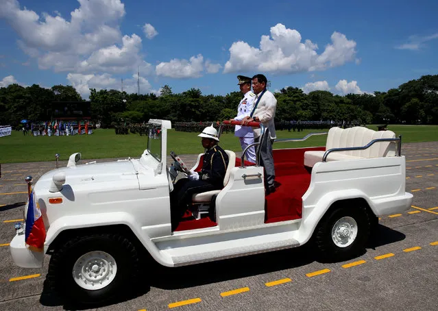 Philippines President Rodrigo Duterte rides in a vehicle as he reviews troops during a military parade at main military Camp Aguinaldo in Quezon city Metro Manila, Philippines July 1, 2016. (Photo by Erik De Castro/Reuters)