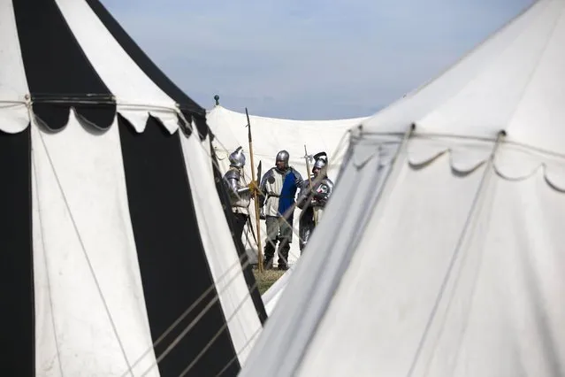 Historical re-enactors in a living history camp prepare their costumes as they take part in an anniversary event for the Battle of Bosworth near Market Bosworth in central Britain August 22, 2015. (Photo by Neil Hall/Reuters)