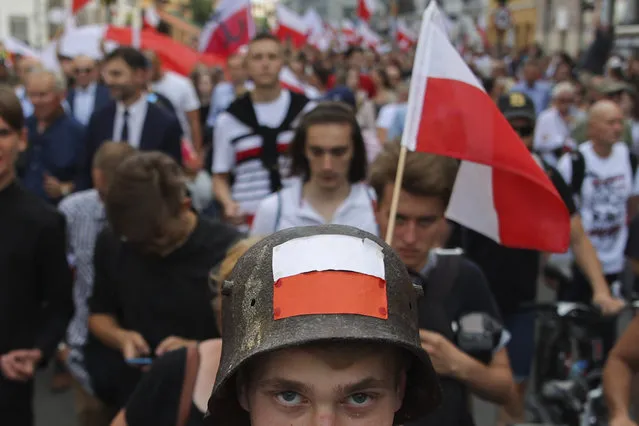 Supporters of the far-right organization National-Radical Camp, ONR, take part in the commemoration of the 1944 Warsaw Uprising, in Warsaw, Poland, Monday August 1, 2022. Poles are marking the 78th anniversary of the Warsaw Uprising, a doomed revolt against Nazi German forces during World War II. (Photo by Michal Dyjuk/AP Photo)