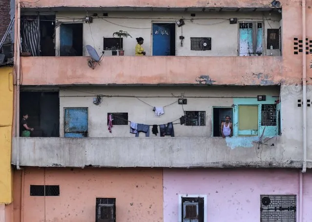 Residents are seen in their balconies during 21-day nationwide lockdown to limit the spreading of coronavirus disease (COVID-19), in New Delhi, India, March 25, 2020. (Photo by Danish Siddiqui/Reuters)