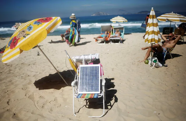 A solar panel is set up to power WiFi access on Ipanema beach in Rio de Janeiro, Brazil, May 3, 2016. (Photo by Nacho Doce/Reuters)
