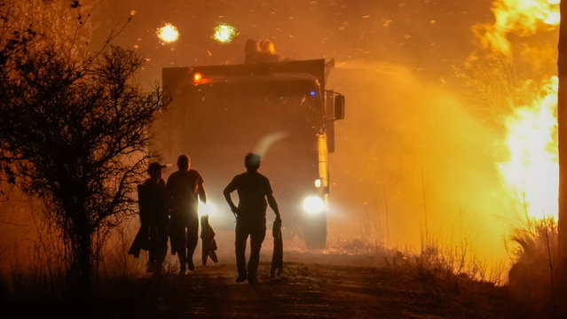 Firefighters work to contain the fires in Cordoba, Argentina, 11 October 2023. Efforts to extinguish forest fire continued this 11 October in the central Argentine province of Córdoba, where the fire forced the evacuation of at least 30 people from surrounding towns. According to the daily fire report of the Argentine Ministry of Environment and Sustainable Development, most of the outbreaks were controlled on Tuesday night, although the outbreak in the northern part of the province in Tulumba, 150 kilometers from the capital of Córdoba, is still worrying (Photo by Lucho Casalla/EPA)