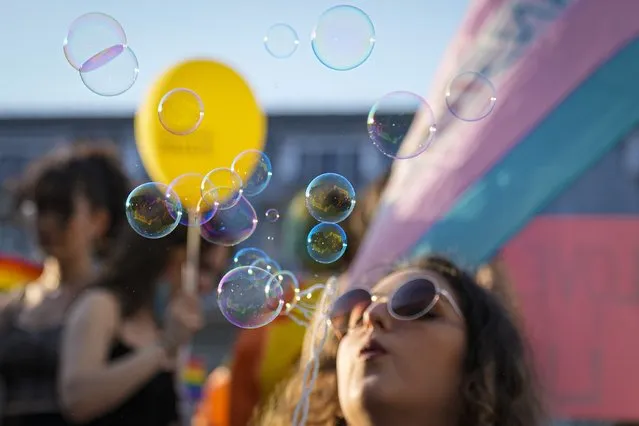 Buildings are reflected in soap balloons during the Bucharest Pride 2021 in Bucharest, Romania, Saturday, August 14, 2021. The 20th anniversary of the abolishment of Article 200, which authorized prison sentences of up to five years for same-s*x relations, was one cause for celebration during the gay pride parade and festival held in Romania's capital this month. People danced, waved rainbow flags and watched performances at Bucharest Pride 2021, an event that would have been unimaginable a generation earlier. (Photo by Vadim Ghirda/AP Photo)