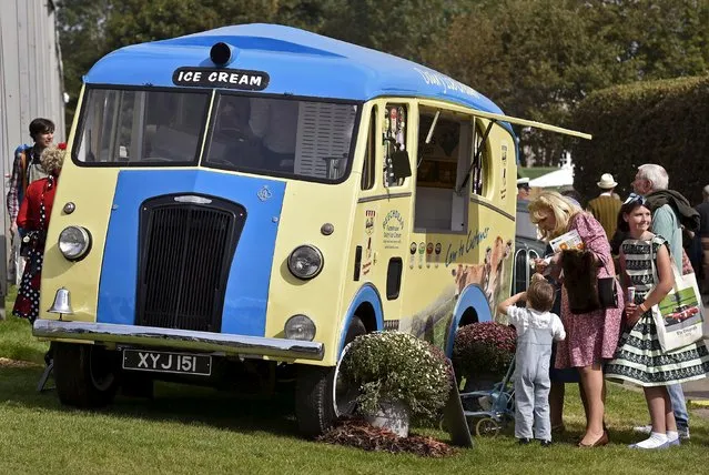 Visitors wait at an ice cream van during the Goodwood Revival historic motor racing festival in Goodwood, near Chichester in south England, Britain, September 11, 2015. (Photo by Toby Melville/Reuters)