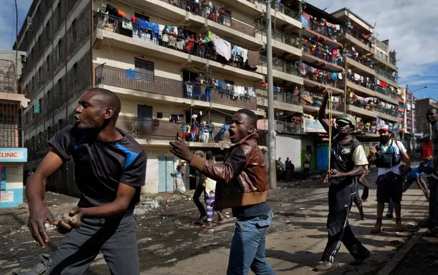 Opposition protesters throw rocks at riot police by hand and with slingshots, during clashes with police in the Mathare slum of Nairobi, Kenya Thursday, October 26, 2017. (Photo by Ben Curtis/AP Photo)