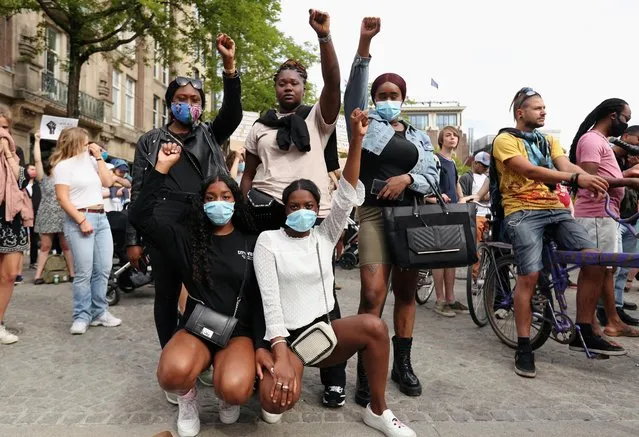 Women pose for a photo as they take part in a protest against the death in Minneapolis police custody of George Floyd, in Amsterdam, Netherlands on June 1, 2020. (Photo by Eva Plevier/Reuters)