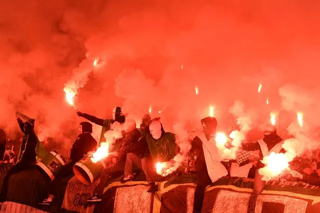VfL Wolfsburg fans let off flares in the stand before winning 2-1 in their DFB Cup match against Eintracht Braunschweig at Eintracht-Stadion in Germany on October 18, 2022. (Photo by Fabian Bimmer/Reuters)