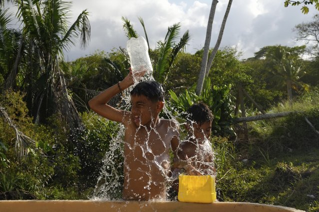 Migrants cool off in Palenque, Panama, Wednesday, February 26, 2025. The migrants are returning from southern Mexico after giving up on reaching the U.S., a reverse flow triggered by the Trump administration's immigration crackdown. (Photo by Matias Delacroix/AP Photo)