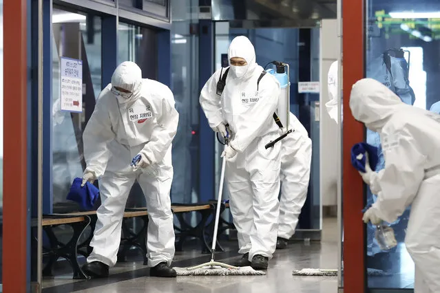 South Korean soldiers wearing protective gears disinfect as a precaution against the new coronavirus at a train station in Daejeon, South Korea, Thursday, June 25, 2020. (Photo by Kim Jun-beom/Yonhap via AP Photo)