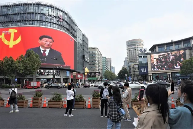 Chinese President Xi Jinping is seen at the end of the Chinese Communist Party's 20th Party Congress on a giant screen a commercial district of Hangzhou in eastern China's Zhejiang province on Sunday, October 23, 2022. China's economic growth accelerated in the latest quarter but still was among the slowest in decades as the country wrestled with repeated closures of cities to fight virus outbreaks. (Photo by Chinatopix via AP Photo)