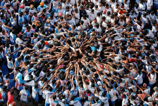 Devotees form a human pyramid to celebrate the festival of Janmashtami, marking the birth anniversary of Hindu Lord Krishna, in Mumbai, India August 25, 2016. (Photo by Shailesh Andrade/Reuters)