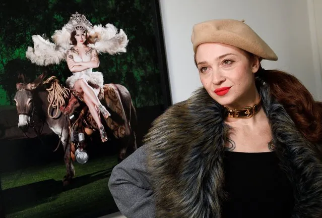 Italian model Janet Fischietto poses next to a photo that portrays her at the preview of the exhibition “Unconventional”, a selection of unseen colour photographs by Italian fashion photographer Gian Paolo Barbieri, in Milan, Italy on November 28, 2022. (Photo by Flavio Lo Scalzo/Reuters)