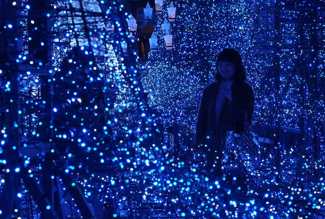 A visitor admires illuminations based on Disney movie “Beauty and the Beast” at Caretta Illumination in Tokyo on December 20, 2017. The illumination event will be displayed until February 14, 2018. (Photo by Kazuhiro Nogi/AFP Photo)