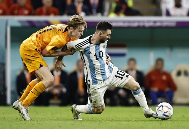 Argentina's forward #10 Lionel Messi (L) fights for the ball with Netherlands' midfielder #21 Frenkie De Jong during the Qatar 2022 World Cup quarter-final football match between The Netherlands and Argentina at Lusail Stadium, north of Doha on December 9, 2022. (Photo by Hamad I Mohammed/Reuters)